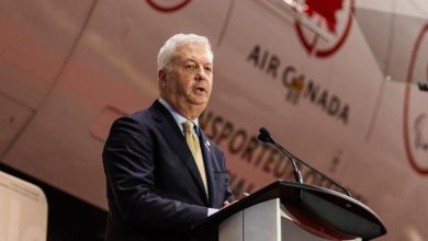 Air Canada CEO Michael Rousseau speaks at a corporate event, as the airline announces his planned retirement following recent controversy.