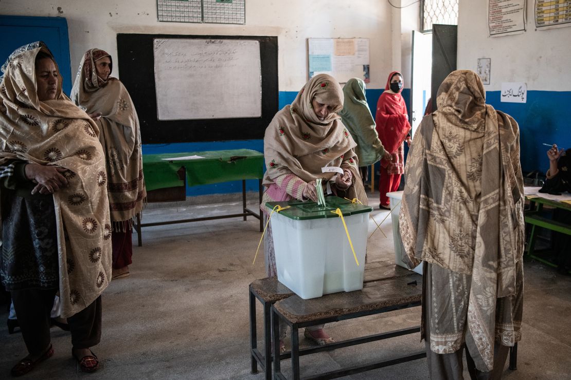 Voters cast their ballots at a polling station during the general election on February 8 in Bhasin.