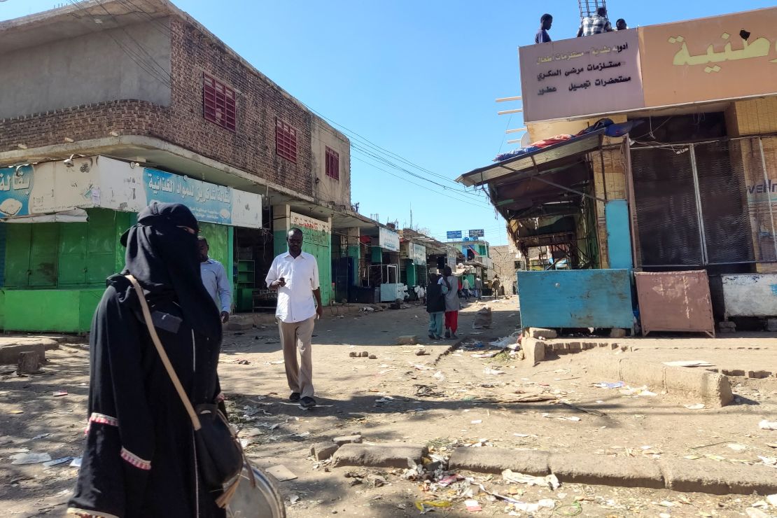 Sudanese civilians walk through a nearly empty road with many shops closed for security reasons in Gedaref city in eastern Sudan on January 10, 2024.