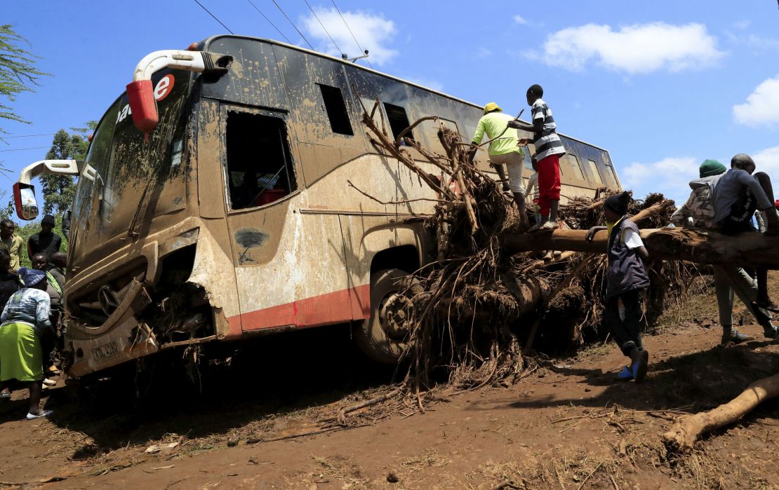 A damaged passenger bus stuck on a fallen tree after heavy flash floods wiped out several homes when a dam burst, following heavy rains in Kamuchiri village of Mai Mahiu, Nakuru County, Kenya, on April 29.