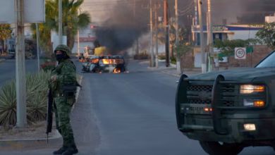 Security forces patrol a street in Mexico following violent clashes after the death of cartel leader Nemesio Oseguera Cervantes.