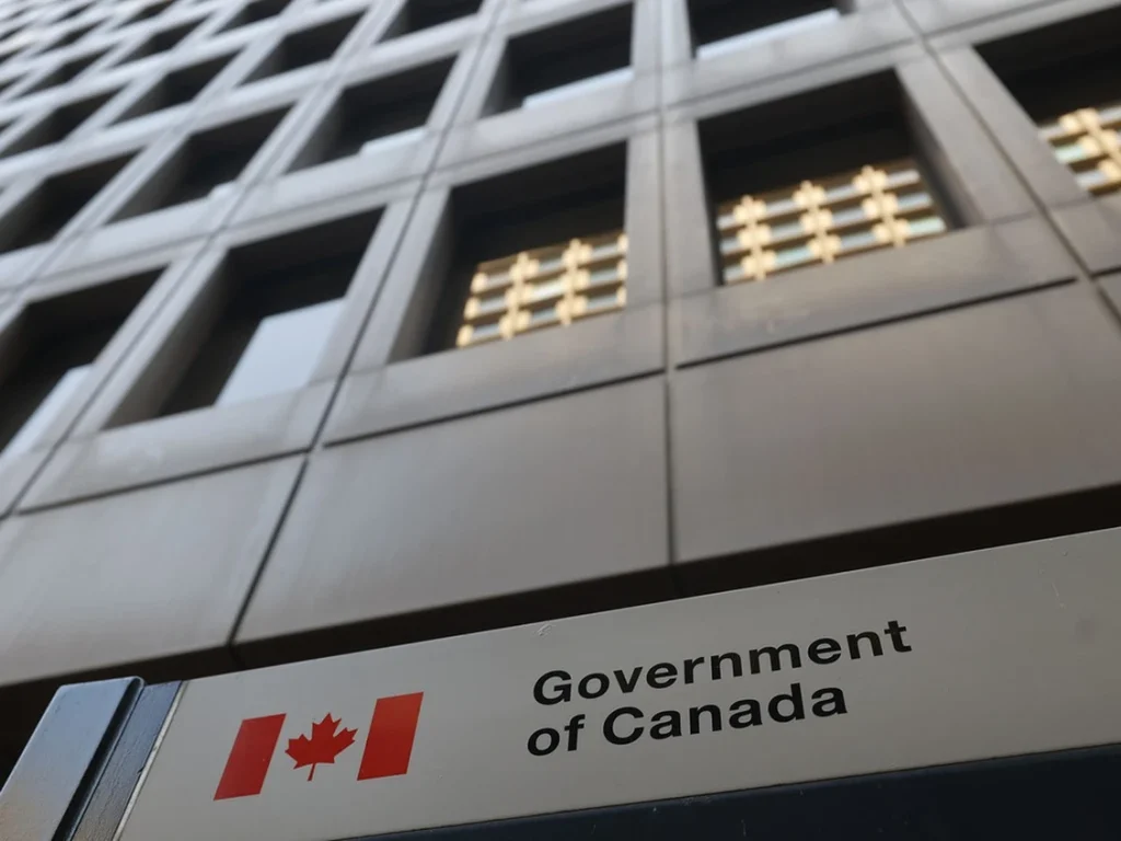 Public servants arrive at a federal government office in Ottawa, where a new early retirement incentive program is expected to reshape staffing and hiring in the coming years.