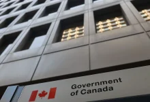 Public servants arrive at a federal government office in Ottawa, where a new early retirement incentive program is expected to reshape staffing and hiring in the coming years.