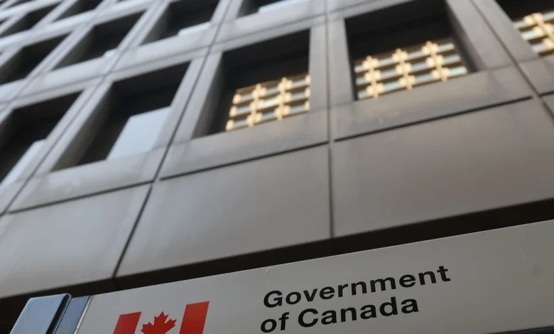 Public servants arrive at a federal government office in Ottawa, where a new early retirement incentive program is expected to reshape staffing and hiring in the coming years.
