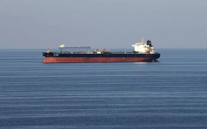 Oil tankers pass through the Strait of Hormuz as global prices rise amid escalating geopolitical tensions.