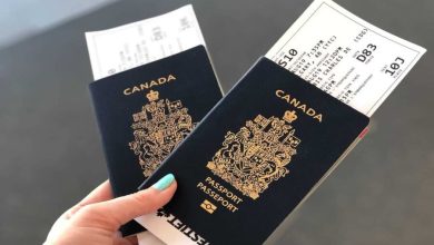 A Canadian passport displayed alongside application forms, as the government introduces a new 30-day processing guarantee or fee refund policy.