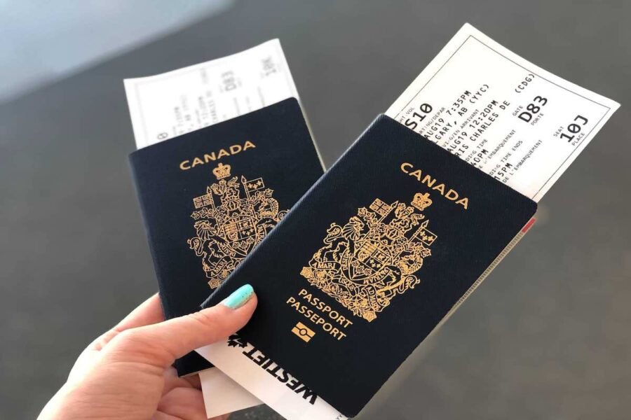 A Canadian passport displayed alongside application forms, as the government introduces a new 30-day processing guarantee or fee refund policy.