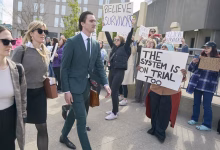 Alex Formenton passes protesters as he arrives at the courthouse in London, Ont., on Thursday, May 8, 2025. THE CANADIAN PRESS/ Geoff Robins